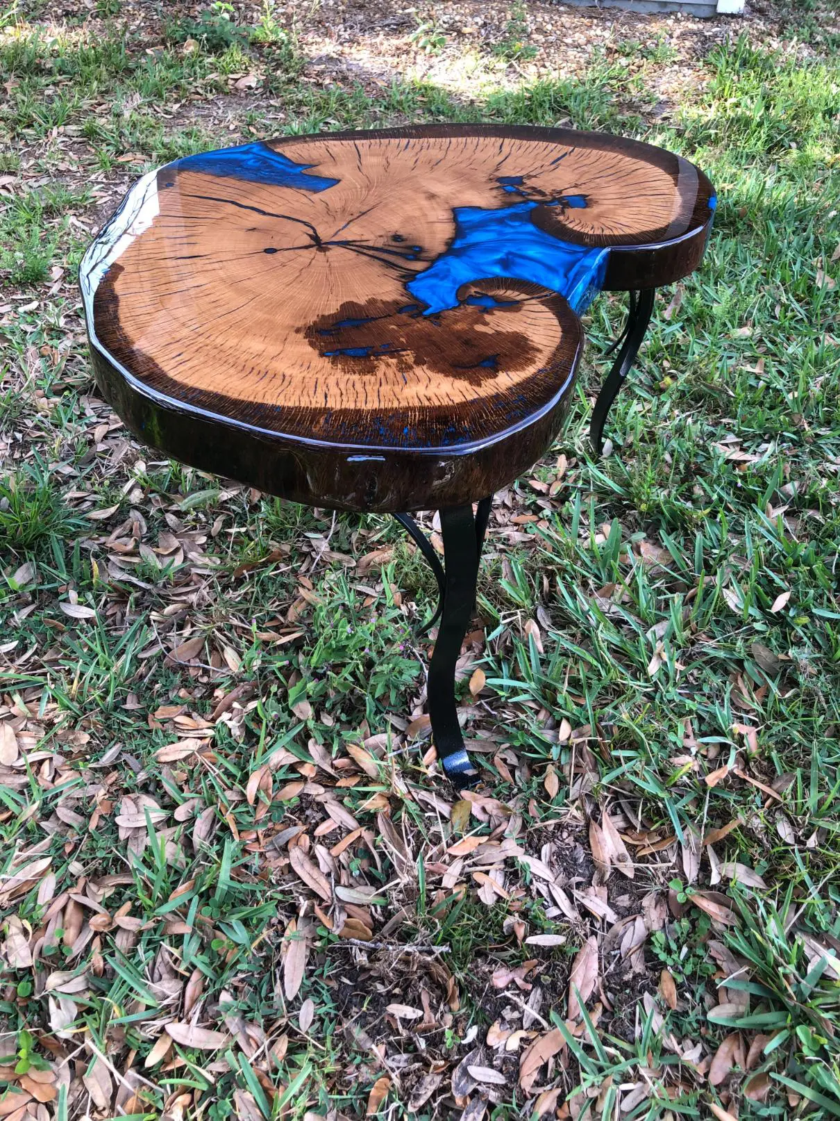 Unique wooden table with a live edge and resin river design.