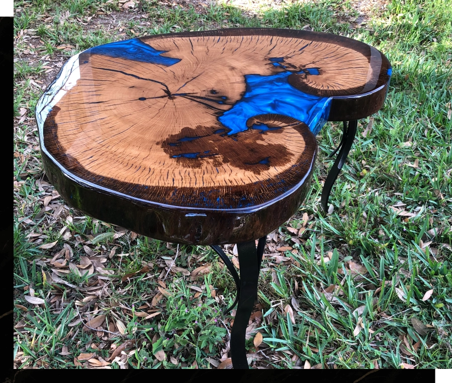 Wooden table with blue resin river design and natural edge.