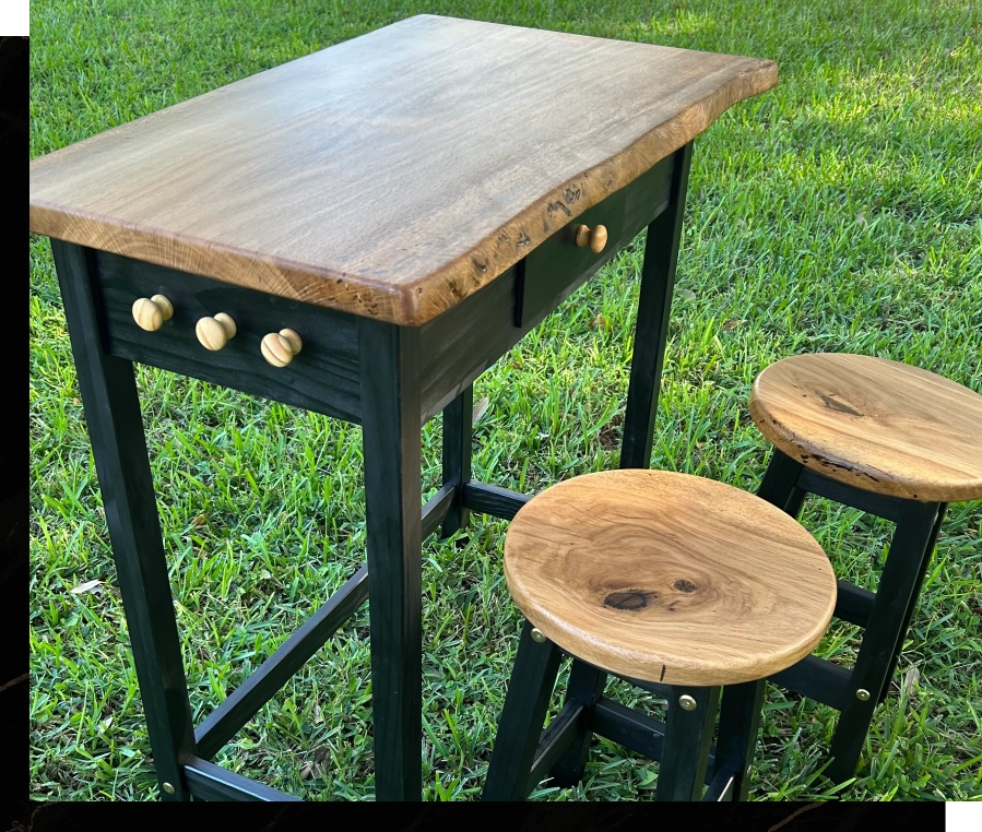 Rustic wooden table with stools on black metal frames outdoors.